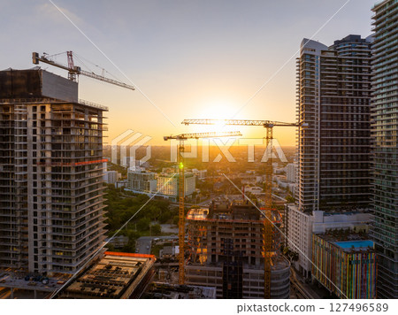 New construction site in Miami, Florida au sunset. Developing residence in American urban area. Concept of housing growth in the USA New construction site in Miami, Florida au sunset. Developing residence in American urban area. Concept of housing growth in the USA 127496589