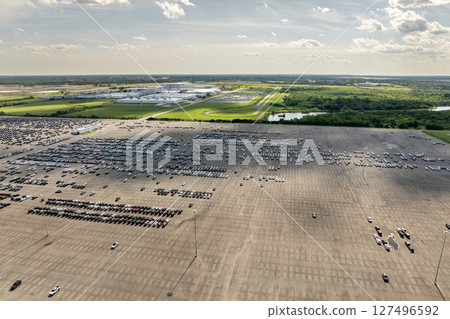 New cars stock at production factory parking lot. Vehicles parked in a row at dealer port terminal. Automotive industry. Import or export of new cars at warehouse 127496592