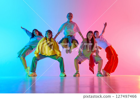 Youthful dance crew celebrates diversity and creative movement in colorful urban performance 127497466