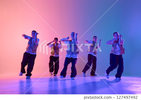 Youthful energy vibrant urban dance crew performing creative expressive choreography 127497492