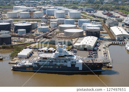 Large luxury yacht under construction in shipyard with cranes. Assembly of sea vessel 127497651