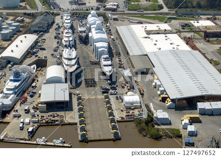 Large luxury yacht under construction in shipyard with cranes. Assembly of sea vessel Large luxury yacht under construction in shipyard with cranes. Assembly of sea vessel 127497652