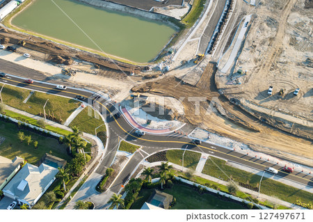 Industrial roadworks. Roundabout on wide American highway under construction. Development of transportation system for rapid transit 127497671