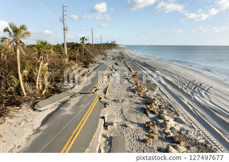 Hurricane storm surge destroyed waterfront road on ocean shore in Florida. Severe damage to transportation infrastructure 127497677