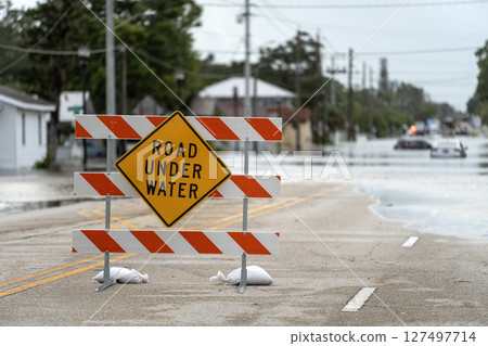 Hurricane Debby flooded street with road closed sign blocking driving of cars in Sarasota, Florida. Safety of transportation during natural disaster concept Hurricane Debby flooded street with road closed sign blocking driving of cars in Sarasota, Florida. Safety of transportation during natural disaster concept 127497714