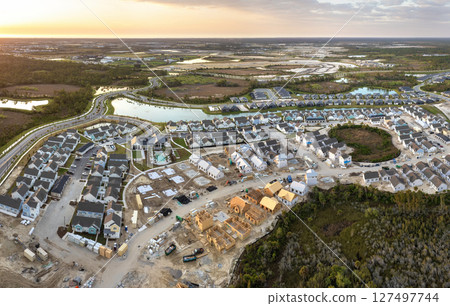 Houses under construction in American suburbs. Development of residential housing. Real estate market in the USA Houses under construction in American suburbs. Development of residential housing. Real estate market in the USA 127497744