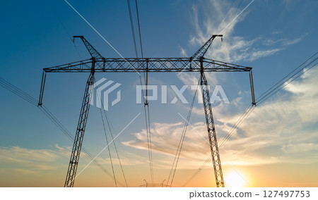 High voltage tower with electric power lines at sunset. Transmission of electricity 127497753
