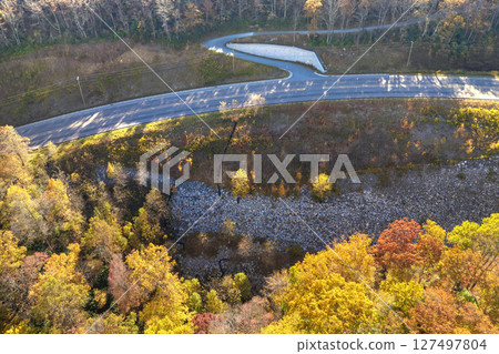 Freeway road with fast moving traffic cars and trucks in North Carolina Appalachian mountains in fall season. Interstate transportation infrastructure in USA Freeway road with fast moving traffic cars and trucks in North Carolina Appalachian mountains in fall season. Interstate transportation infrastructure in USA 127497804