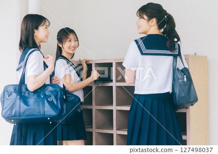 A high school girl greets in front of the shoe locker 127498037