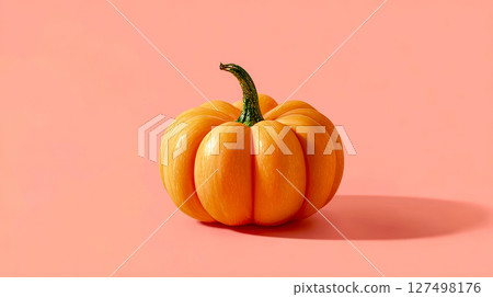 Whole orange pumpkin on pink background 127498176