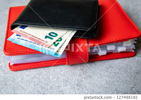 Black partmone with european money. Bills in leather wallet for commerce concept. 127498192