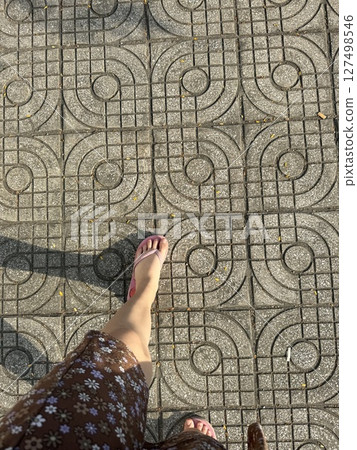 vertical photo girl walking on tiles legs shot from above street summer 127498546