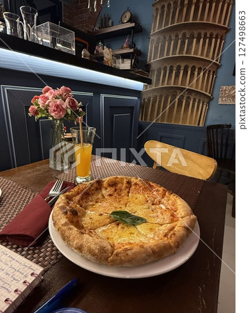 Pizza on the table, a glass of juice Pizza on the table, a glass of juice 127498663