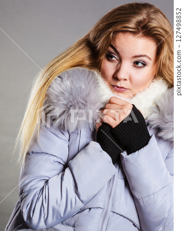 Woman wearing winter warm furry jacket Woman wearing winter warm furry jacket 127498852