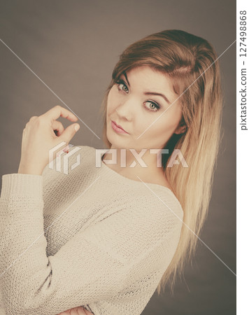 Confused young blonde woman looking annoyed 127498868
