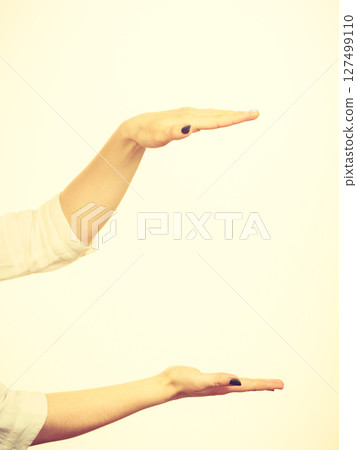 Woman hands indicating area of frame, copy space for product 127499110