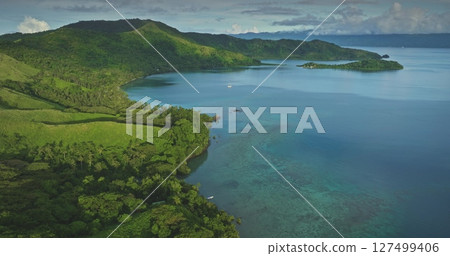 Aerial drone footage revealing the stunning beauty of a tropical Fiji island, showcasing lush vegetation, crystal-clear turquoise waters, and vibrant coral reefs. Amazing nature travel background Aerial drone footage revealing the stunning beauty of a tropical Fiji island, showcasing lush vegetation, crystal-clear turquoise waters, and vibrant coral reefs. Amazing nature travel background 127499406