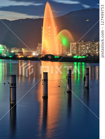 Orange pillars illuminating Lake Biwa in the twilight Orange pillars illuminating Lake Biwa in the twilight 127499753