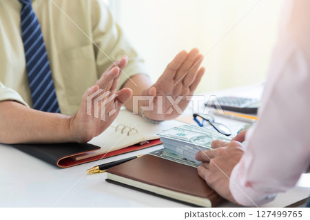 Business man refusing money to take the bribe. The concept of corruption and anti bribery. 127499765