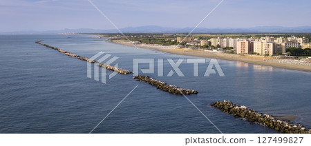 Panorama of italian sandy beaches with umbrellas and gazebos at sunny day 127499827