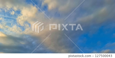 Evening sky with yellowish-gray clouds. Evening sky with yellowish-gray clouds. 127500043