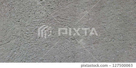The surface of an old concrete slab. Traces of gray paint on concrete. 127500063