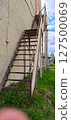 Metal staircase to the second floor on the side of the building. 127500069
