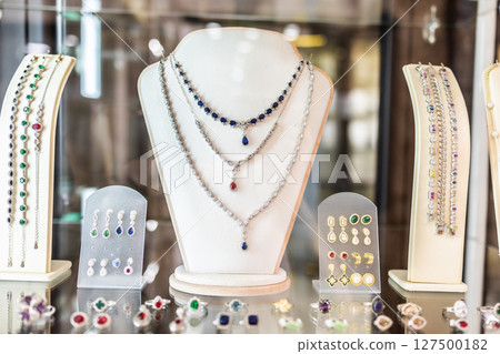 Elegant jewelry display with gemstones and necklaces. Luxury design, fashion accessories, and retail presentation. 127500182