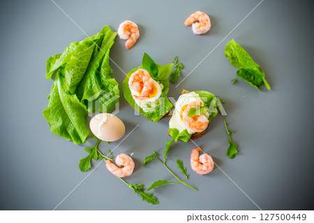 Light sandwich with seafood and greens on gray background Light sandwich with seafood and greens on gray background 127500449
