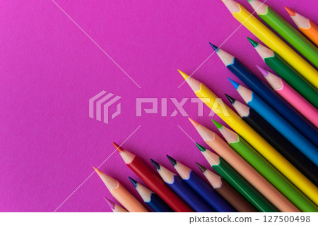 A lot of color pencils on the bright pink background. Close up. Design concept. Space for text. A lot of color pencils on the bright pink background. Close up. Design concept. Space for text. 127500498