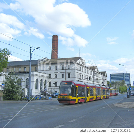 red tram going on street of Lodz. Colored tramway going along city red tram going on street of Lodz. Colored tramway going along city 127501021