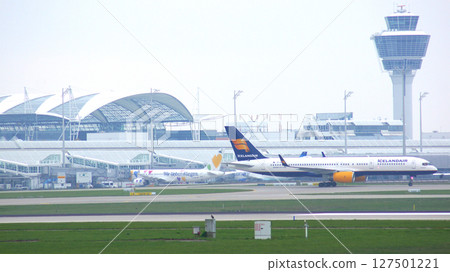 Munich, Germany, October 11, 2015: Aircraft with Terminal and Tower Munich, Germany, October 11, 2015: Aircraft with Terminal and Tower 127501221
