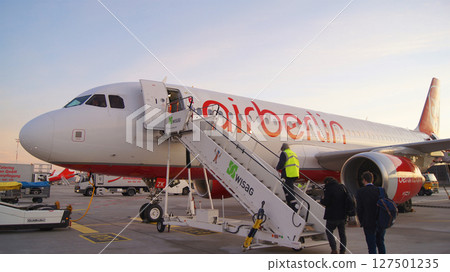 Berlin, Germany, December 10, 2015: Air Berlin A320 Boarding via Mobile Stairway at Tegel Airport in Early Morning Berlin, Germany, December 10, 2015: Air Berlin A320 Boarding via Mobile Stairway at Tegel Airport in Early Morning 127501235