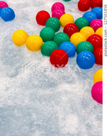 Colorful plastic balls floating in bubbling water 127501856