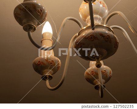 Vintage Rose Chandelier with Warm Light. Antique Decorative Ceiling Lamp. Cream and Brown Floral Fixture. Rustic Interior Lighting. 127502235