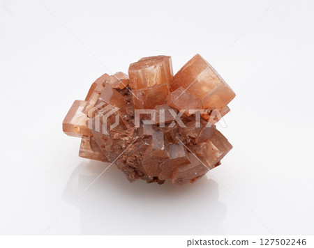 Natural Aragonite Crystal Formation: Warm Orange Geometric Mineral Specimen, Textured Cubic Structure, Isolated Studio Shot on White Background Natural Aragonite Crystal Formation: Warm Orange Geometric Mineral Specimen, Textured Cubic Structure, Isolated Studio Shot on White Background 127502246