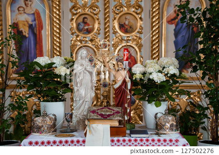 Eastern Orthodox Church Altar with Crucifix and Flowers, Golden Iconostasis, White Hydrangeas, Religious Ceremony Interior Scene, Vibrant Spiritual Art. Eastern Orthodox Church Altar with Crucifix and Flowers, Golden Iconostasis, White Hydrangeas, Religious Ceremony Interior Scene, Vibrant Spiritual Art. 127502276