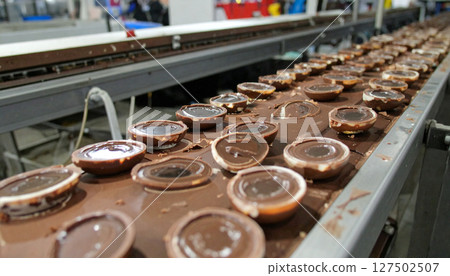 Chocolate factory conveyor belt with glowing candy geodes cracking open. Generated Image 127502507