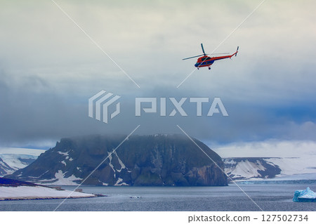 Helicopter brings scientists and extreme tourists on harsh polar Islands 127502734