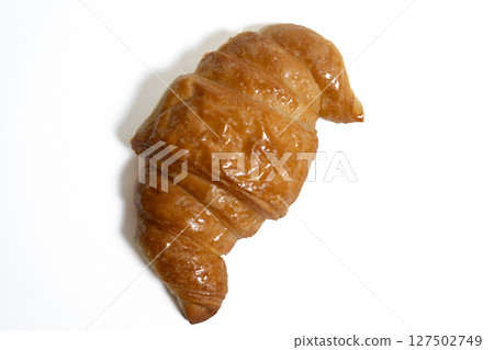 Golden croissant isolated on white background food photography Golden croissant isolated on white background food photography 127502749