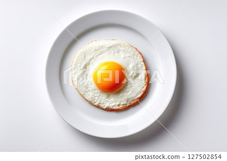 Top view of sunny-side up egg on white plate with white background Top view of sunny-side up egg on white plate with white background 127502854