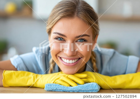Smiling Woman Cleaning Table with Yellow Gloves Smiling Woman Cleaning Table with Yellow Gloves 127502894