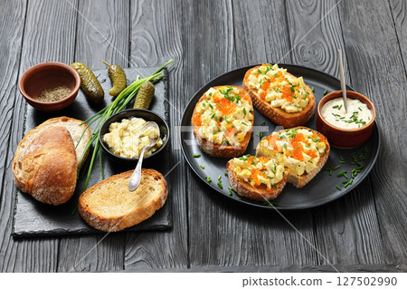 deviled egg salad and red caviar on toast 127502990