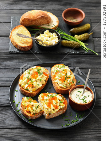 deviled egg salad and red caviar on toast deviled egg salad and red caviar on toast 127502991