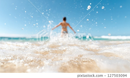 Woman Walking into Sea, Blurred Background Woman Walking into Sea, Blurred Background 127503094