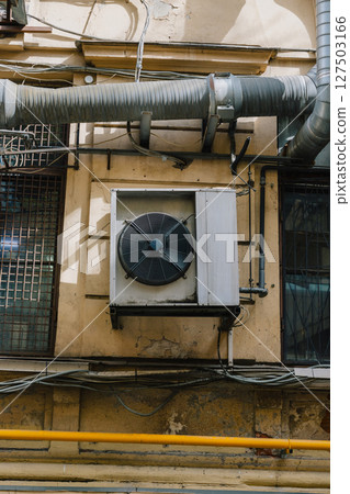 building with large air conditioner on wall. Ventilation air conditioning. cooling down in summer. 127503166
