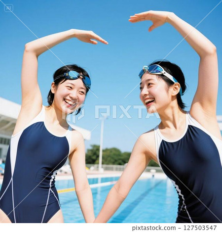 Two girls in competitive swimsuits stretching with smiles on their faces. 127503547