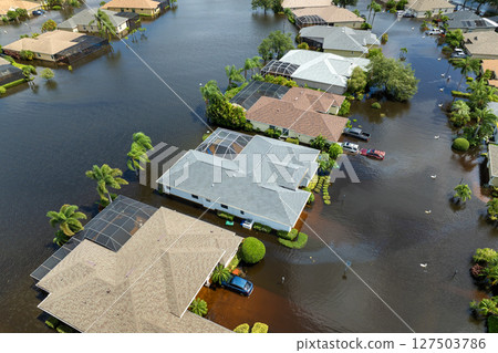 Flooded residential area with underwater cars and houses from hurricane rainfall water in Florida suburban community. Aftermath of natural disaster in southern USA Flooded residential area with underwater cars and houses from hurricane rainfall water in Florida suburban community. Aftermath of natural disaster in southern USA 127503786