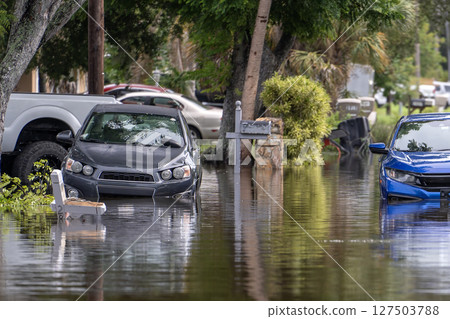 Flooded Florida street with stuck cars after hurricane Debby rainfall surrounded with water. Consequences of natural disaster Flooded Florida street with stuck cars after hurricane Debby rainfall surrounded with water. Consequences of natural disaster 127503788