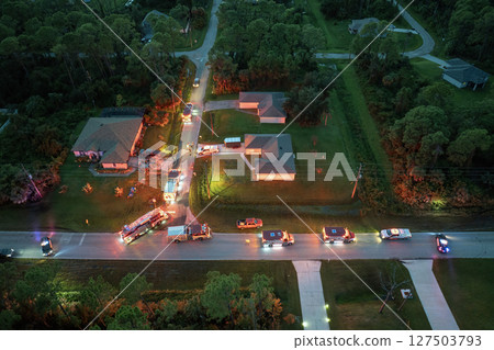 First responders arrived at fire alarm call ready to extinguish fire of burning house. Emergency service personnel responding to potential fire hazard at Florida home 127503793